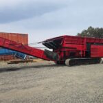 Red Hammel 950 shredder on tracks with discharge conveyor
