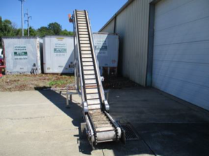 Flexwall stainless steel Z-style conveyor with flighted belt outdoors