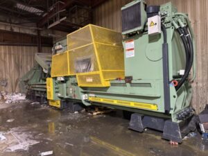 Bollegraaf HBC 120 baler with yellow guard in a warehouse