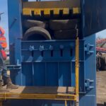 Blue high density vertical tire baler with tires in the chamber