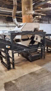 Industrial Magnetics 36 inch drum magnet on its stand with conveyor
