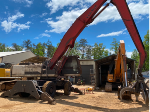 Linkbelt 360 material handler with red boom and grapple