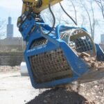 Okada trommel bucket on an excavator screening debris