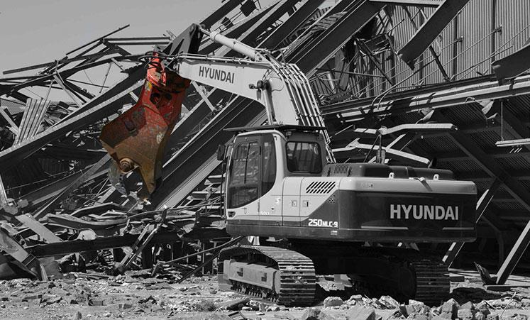 RSS scrap shear mounted on a Hyundai excavator in a demolition site