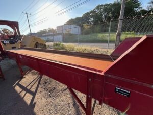 Red CS Bell sorting conveyor, side view outdoors
