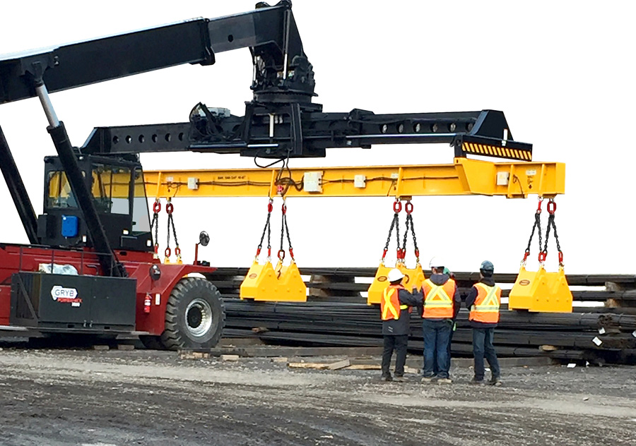 Lifting beam magnets on a reach stacker