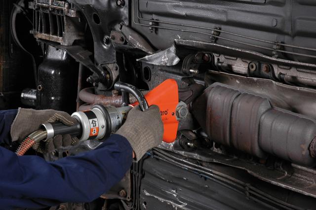 Holmatro handheld shear cutting a catalytic converter from a vehicle