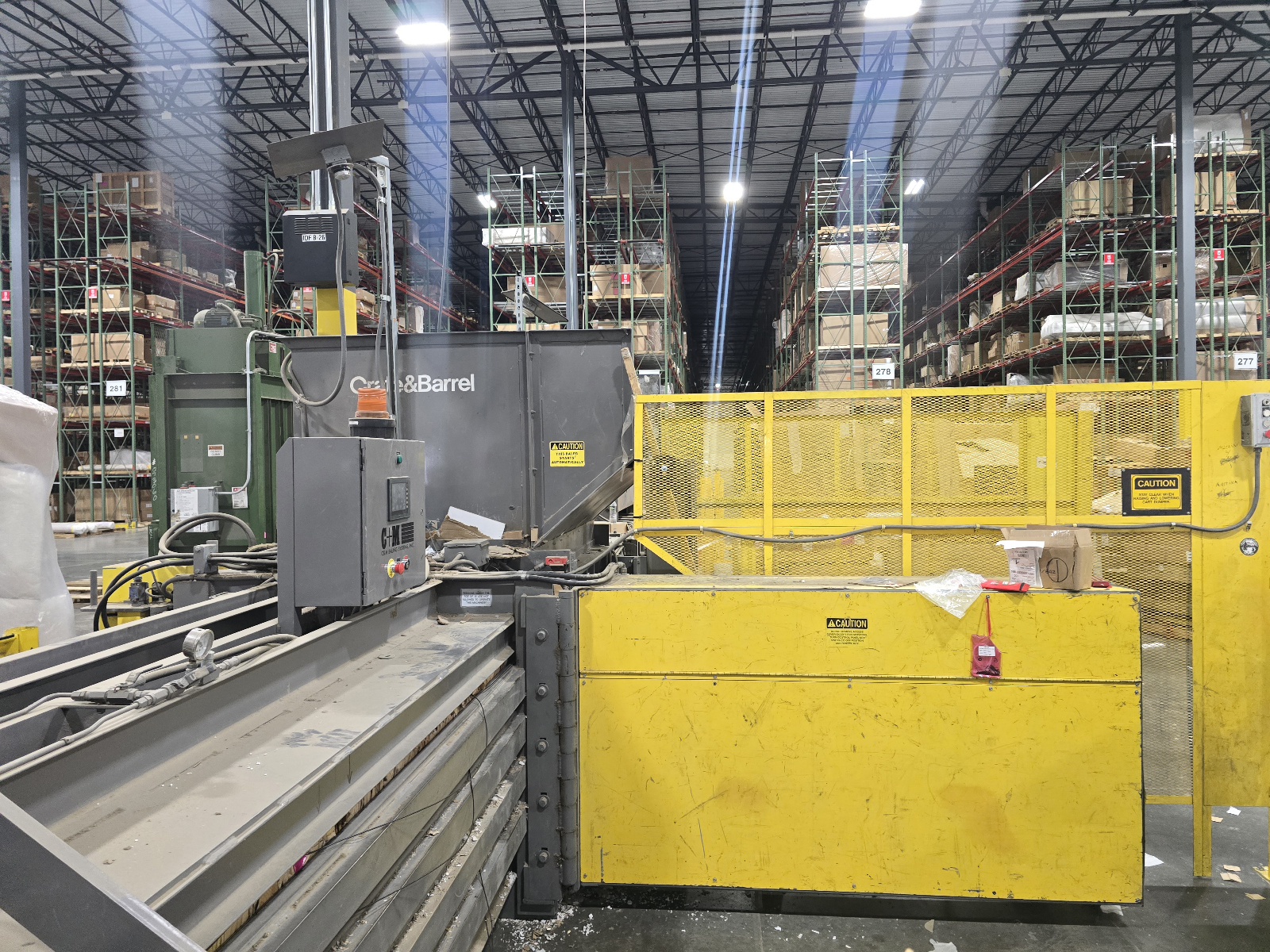Auto tie baler with yellow safety fencing