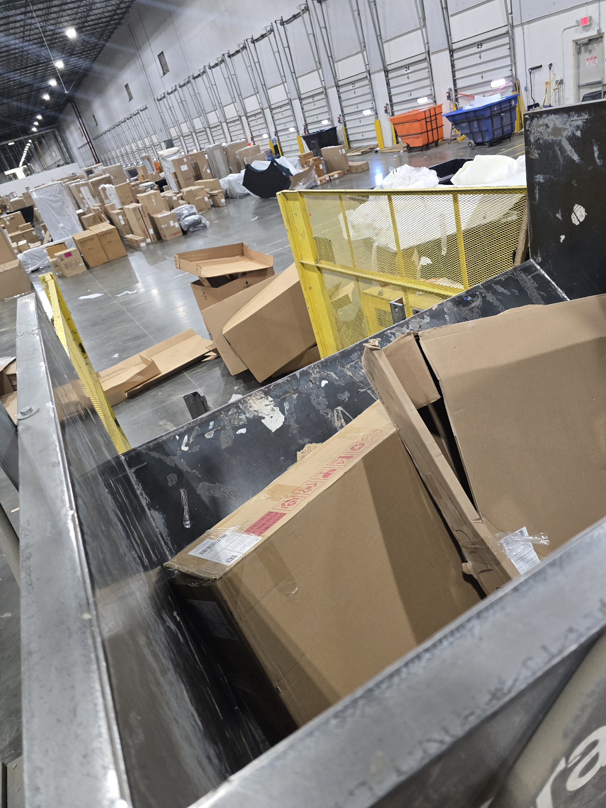 Cardboard boxes in the baler feed hopper