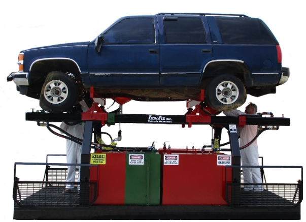 Vehicle rack and drainage system with an SUV raised for fluid removal
